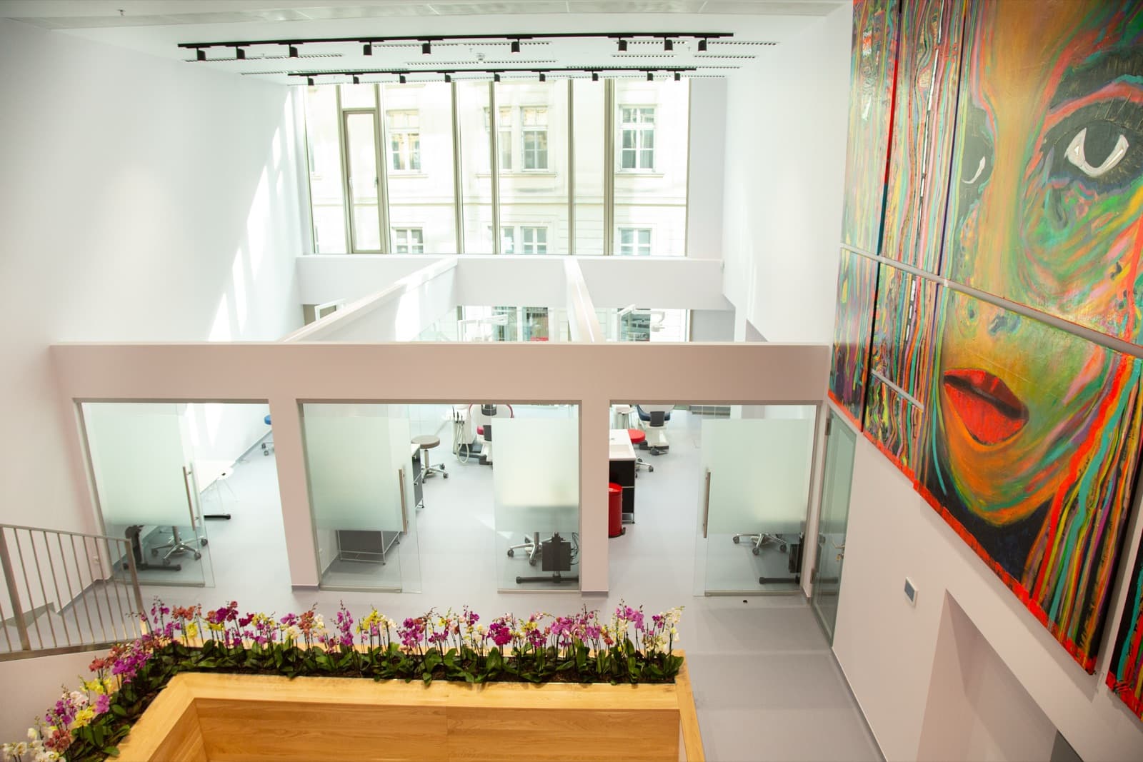 View from the gallery of light practice rooms with a large colourful artwork.